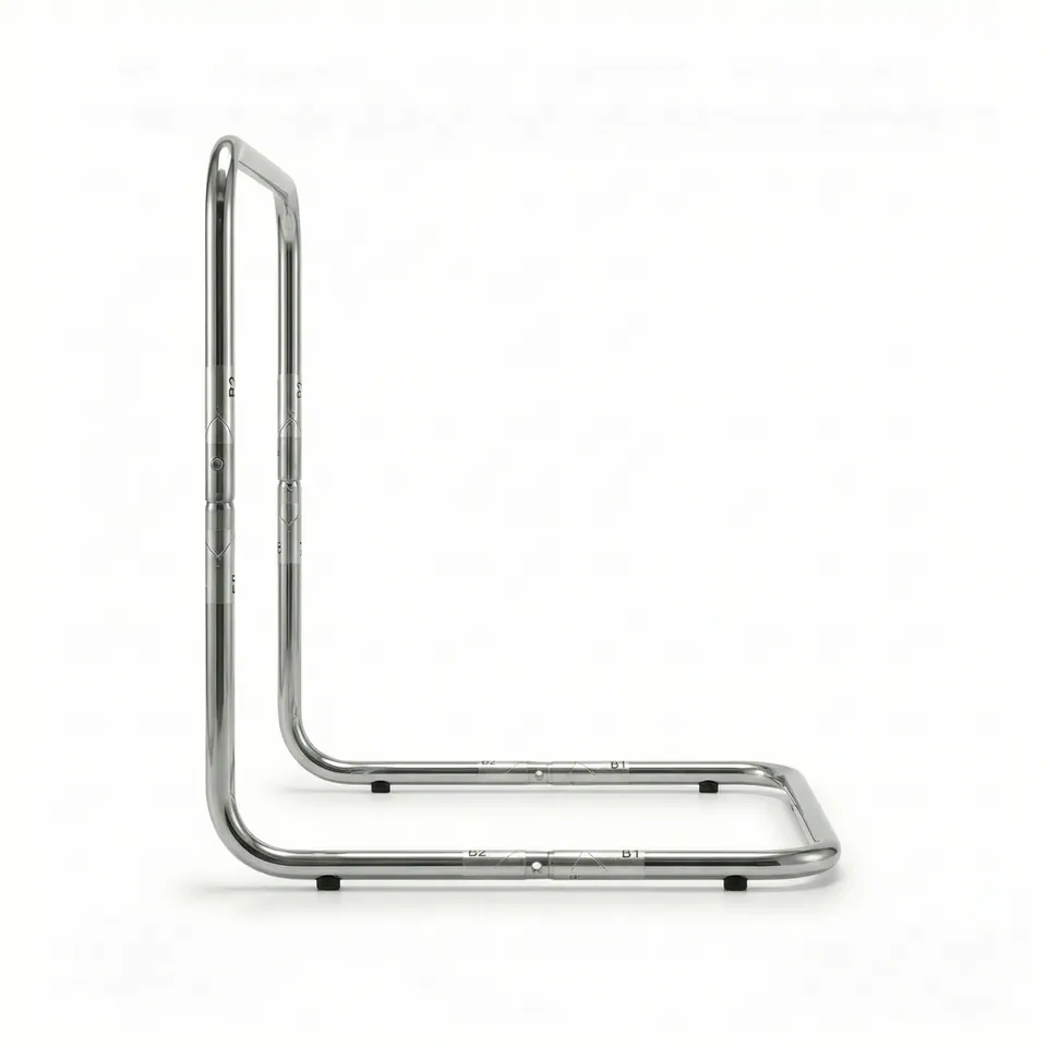 Side profile of a chrome tubular L-frame on white with a vertical back, flat base, printed joint marks and black rubber feet