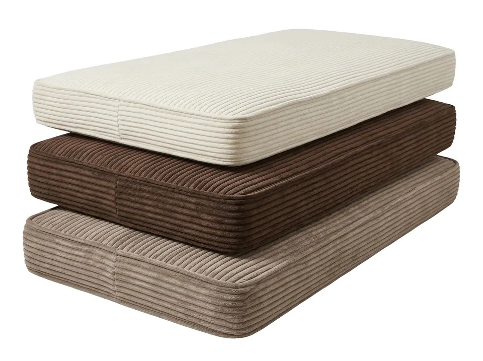 Cream, chocolate and taupe corduroy bench cushions stacked on white, showing wide ribs and self-piped box borders