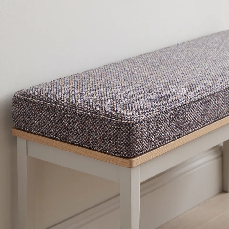 Slate blue and peach flecked tweed-look box cushion with fine piping on a gray-painted hallway bench with oak top