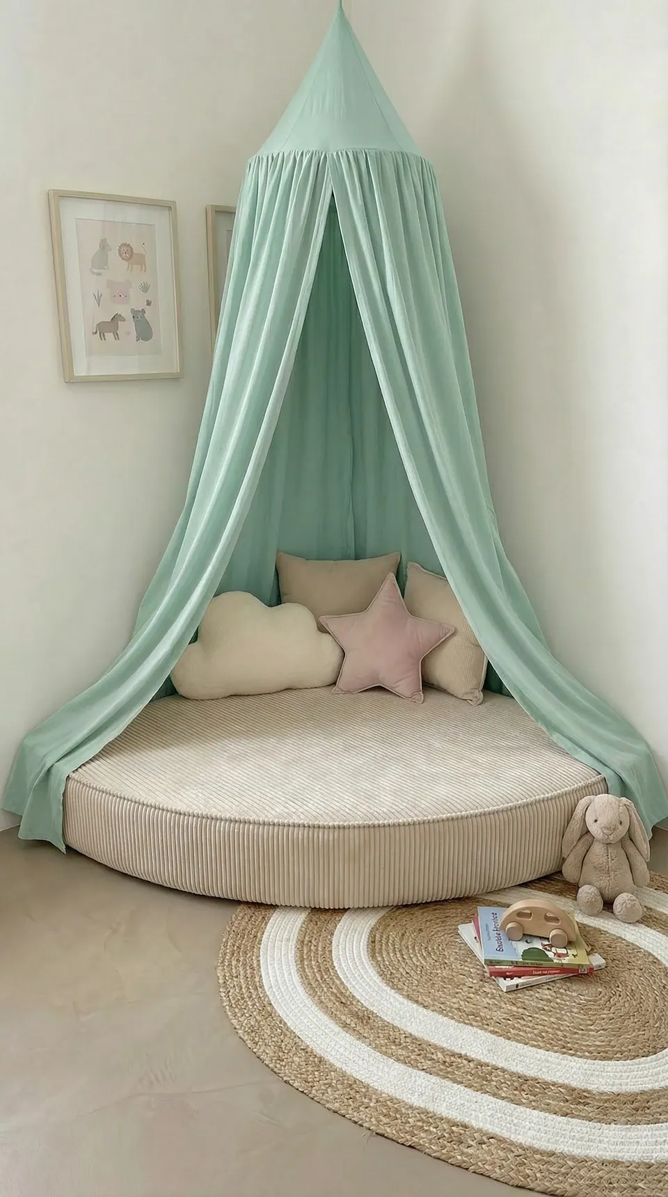 Oatmeal corduroy corner floor cushion under a mint green canopy with cloud, blush star and taupe pillows and plush bunny