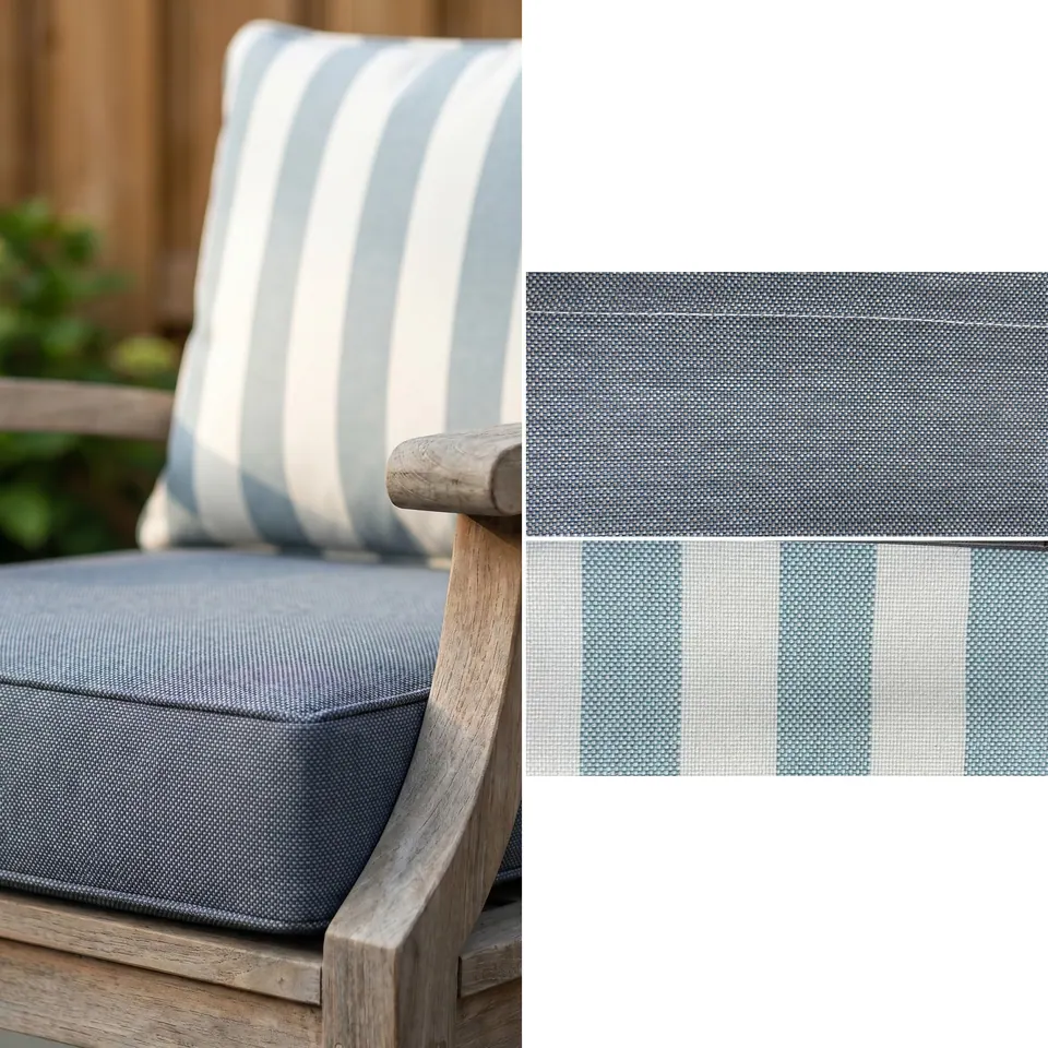 Slate blue piped box seat cushion and sky blue and white stripe back cushion on a weathered teak armchair by a cedar fence