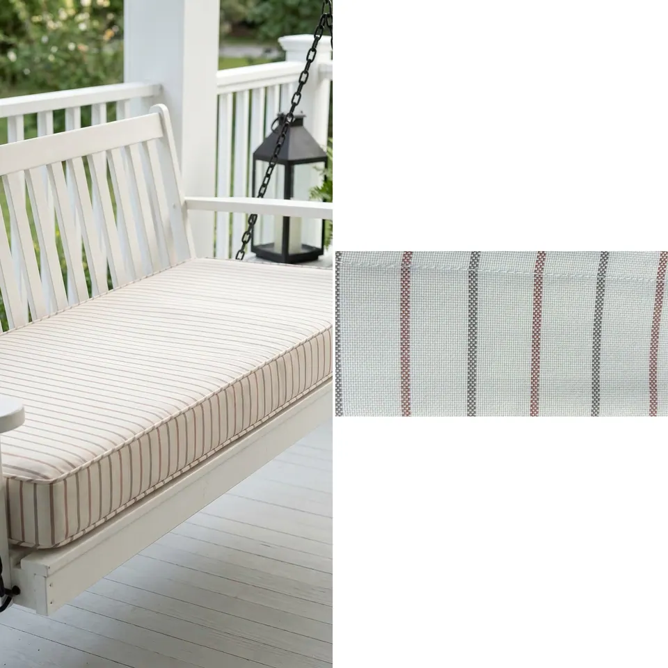 Ivory porch swing cushion with thin red and gray pinstripes and self piping on a white swing, fabric strip beside it