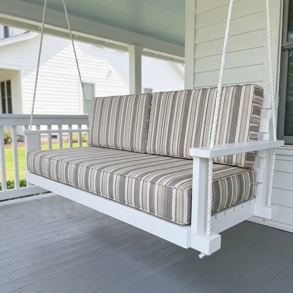 Taupe, gray and ivory herringbone stripe seat and back cushions on a white rope-hung porch swing
