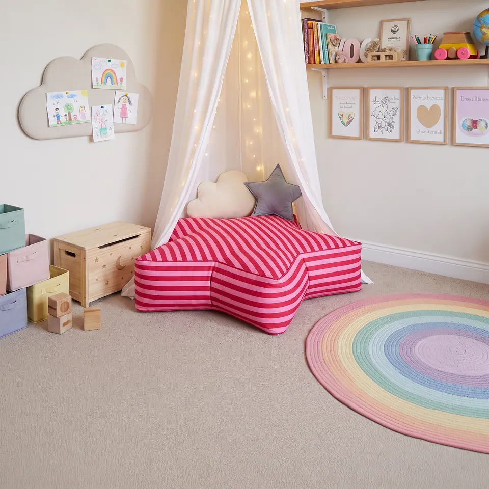 Fuchsia and pink striped star floor cushion under a white fairy-light canopy with a cloud and a star pillow