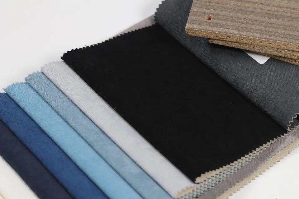 Jet black brushed linen-look upholstery swatch with silver, sky blue and navy strips fanned below