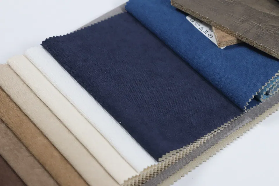 Midnight navy linen-look fabric swatch with white, cream and camel strips and cobalt behind