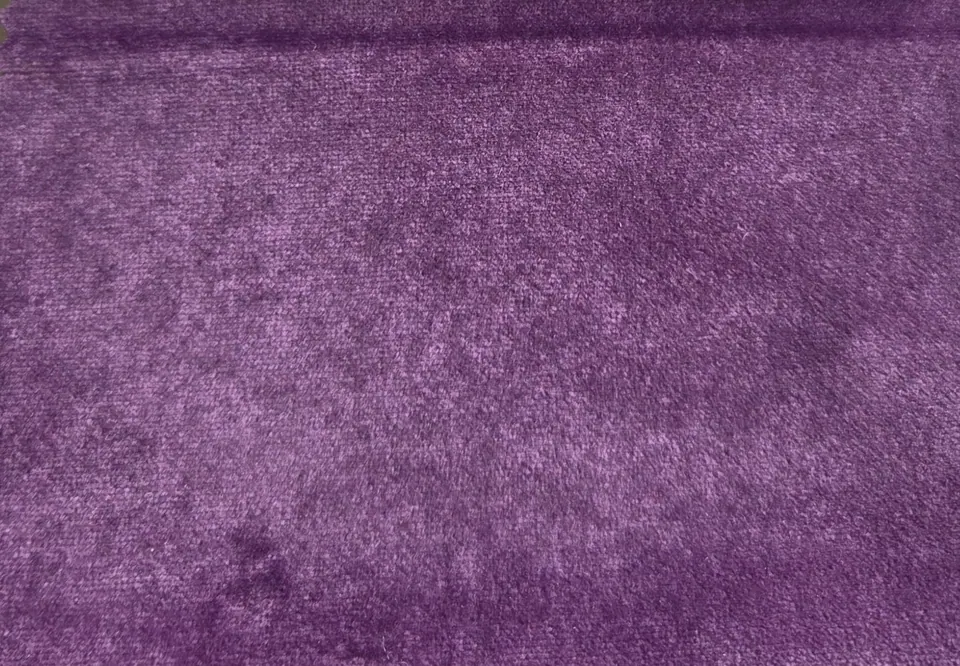 Deep purple velvet swatch with mottled violet highlights, a plum-toned fold on top and darker handled patches