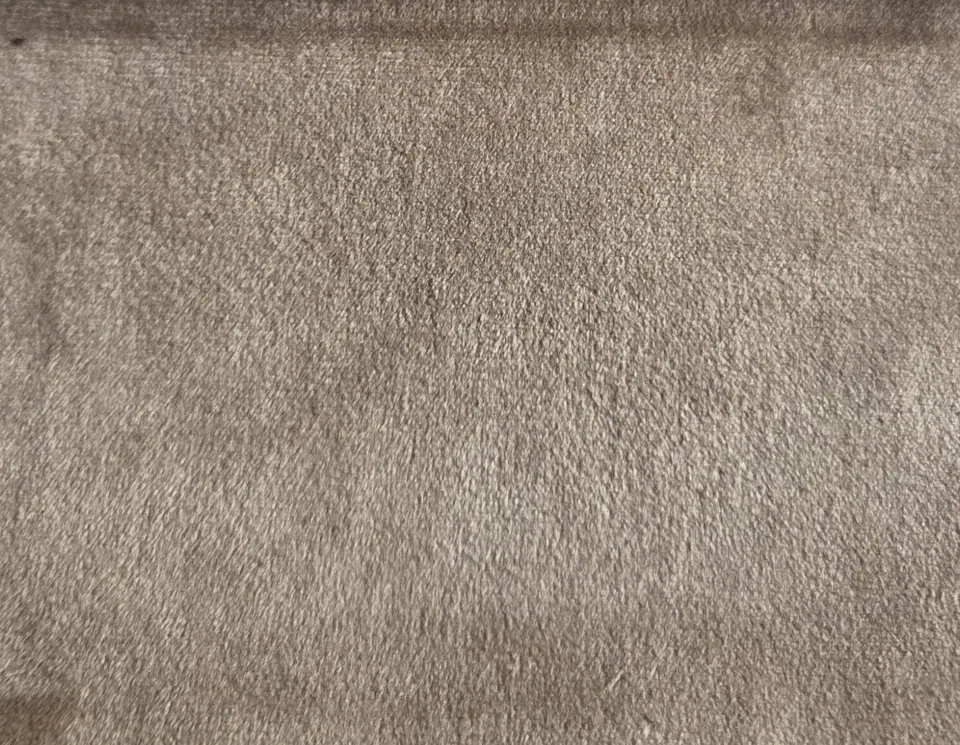 Mushroom beige-taupe velvet sample with short even pile and a softly folded upper edge