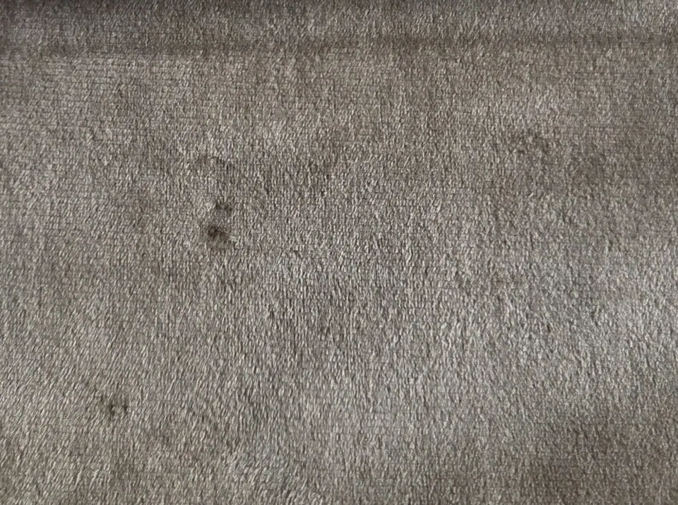 Warm taupe velvet fabric swatch, gray-brown short pile with a darker folded edge along the top