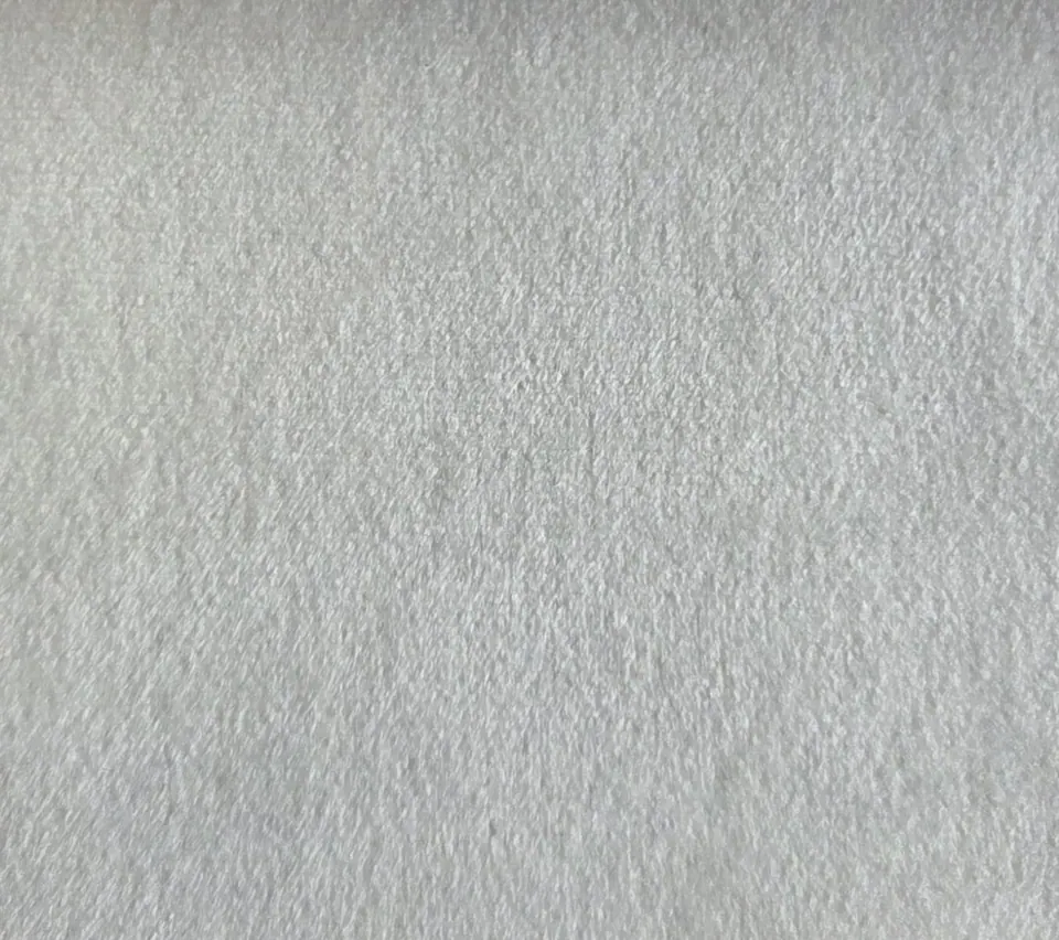 Close-up swatch of white cream short-pile velvet showing a dense, soft nap with slight crush marks